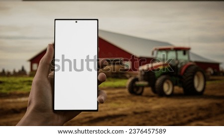 CU Male farmer checking his phone near the farm, blank screen phone mockup