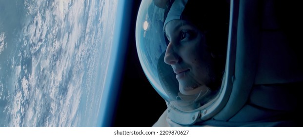 CU Portrait of Caucasian female astronaut during spacewalk on the Earth orbit. Space exploration - Powered by Shutterstock