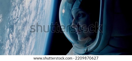 CU Portrait of Caucasian female astronaut during spacewalk on the Earth orbit. Space exploration