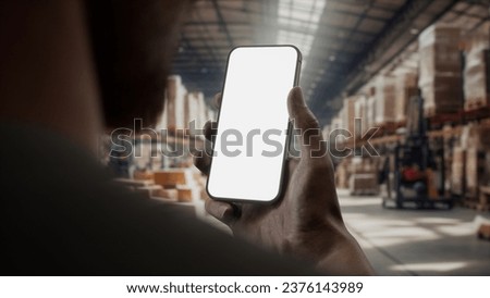 CU View of African-American Black male worker using smartphone inside huge warehouse. Transparent PNG for screen replacement
