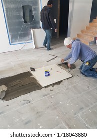 Cuauhtemoc Chihuahua Mexico - April 29 2020: Workers Installing Flooring Tiles In A Modern House, Lots Of Tools Very Messy In The House Constructioning Home! 