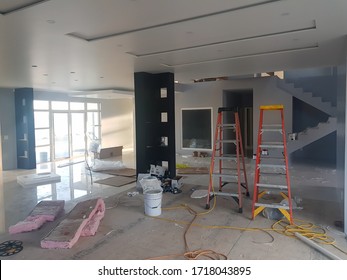 Cuauhtemoc Chihuahua Mexico - April 29 2020: Workers Installing Flooring Tiles In A Modern House, Lots Of Tools Very Messy In The House Constructioning Home! 