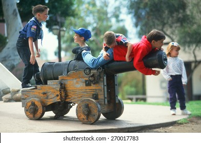 Cub Scouts Playing On A Historical Cannon