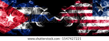 Cuba, Cuban vs Liberia, Liberian smoky mystic flags placed side by side. Thick colored silky travel abstract smokes banners 