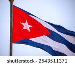 Cuba Flag Waving on flagpole, close up. Cuba flag flaping in wind. Close-up of an Cuban flag flying in the wind against a background of clear sky. Cuba flag full frame