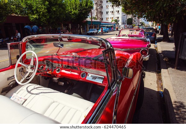 Cuba, Havana - 18 February 2017: beautiful\
retro vintage cars in the colourful streets. Cuba have many old\
american cars restaured.
