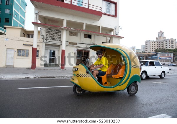 CUBA, Havana MAY 6, 2016.Coco taxi driving in a\
Street of Havana. Cuba.