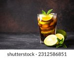 Cuba Libre alcoholic cocktail on dark background.
