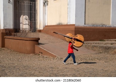 Cuba, Trinidad City, A Boy Carrying Cello