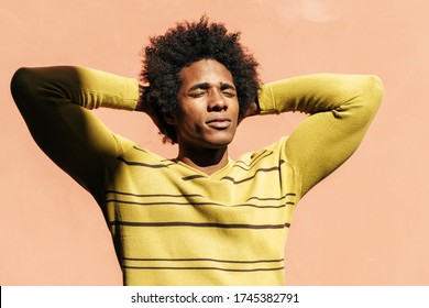 Cuban Black Man Enjoying The Andalusian Sun With His Eyes Closed On His Trip To Granada, Spain.