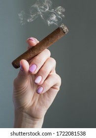 Cuban Cigar In Hand. A Woman Hand Holding A Burning Cigar.