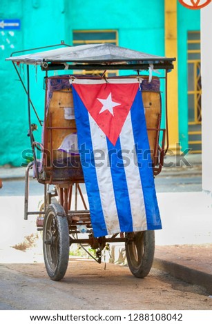 Cuban cycle taxi with Cuban flag,Cycle taxi in Old Havana, Cuba. Tricycle made into a taxi. Cheap transport bike for local and tourist in Havana