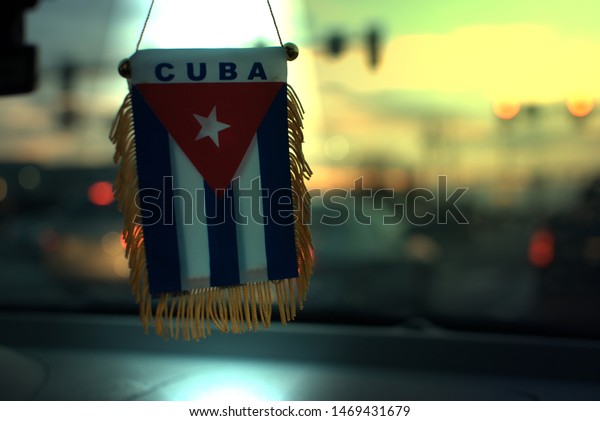 Cuban flag in my car, taken in Lancaster,\
Pennsylvania at the golden hour\
...