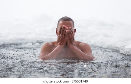 Cuban man swims in an ice hole in winter