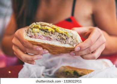 Cuban Sandwich Closeup Woman Holding Local Food At Typical Cafe Outside. Pressed Cuban Bread With Roasted Pork, Salami Sausage, Swiss Cheese, Mustard, Typical Cuba Dish.