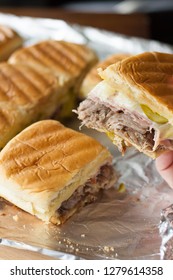 Cuban Sliders Made With Braised Pork Shoulder, Sweet Ham, Pickles, Swiss, And Yellow Mustard. 