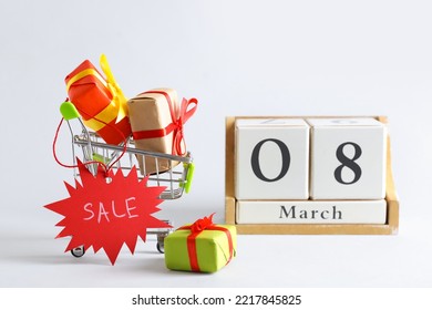 Cube Calendar, Shopping Cart With Gift Boxes And Tag With Word SALE On Light Background