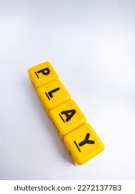 A cube shape toy with Play text, word play with copy space on white background