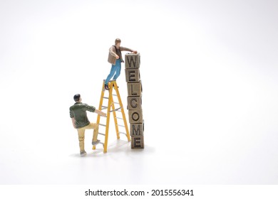 a cube of text welcome with the worker figure