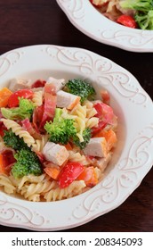 Cubed Cold Chicken With Brocolli, Grape Tomato And Orange Pepper Combined With Fusilli Pasta And Garnished With Crisp Bacon Bits And Buttermilk Yogurt Dressing For A Healthy Summer Salad