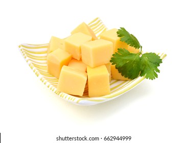 Cubes Of Cheddar Cheese Isolated In Bowl On White 