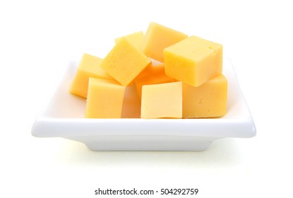 Cubes Of Cheddar Cheese Isolated In Plate On White 