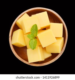 Cubes Of Cheddar Cheese In Wooden Bowl  On White 