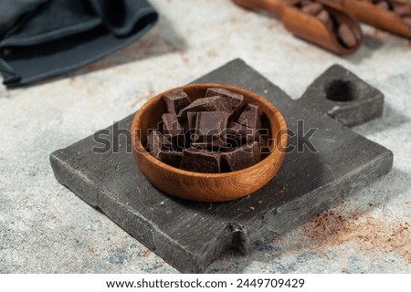 Cubes of dark artisan chocolate in a bowl. Bitter chocolate. Artisan chocolate pieces 