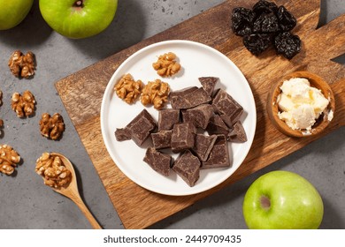 Cubes of dark artisan chocolate. Rich dark chocolate with walnuts and dried fruit - Powered by Shutterstock