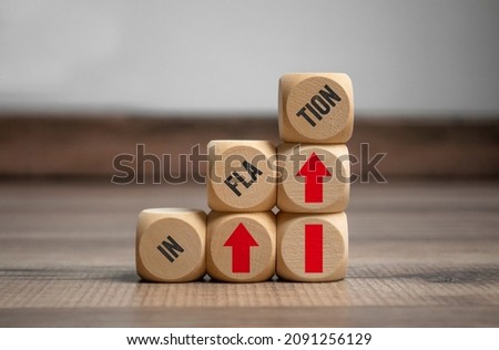 Cubes, dice or blocks with inflation on wooden background