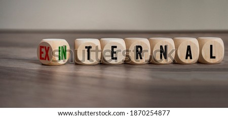 Cubes, dice or blocks showing the words external and internal on wooden background