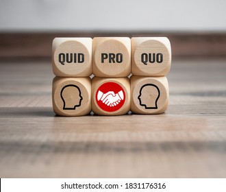 Cubes and dice with business message quid pro quo on wooden background
