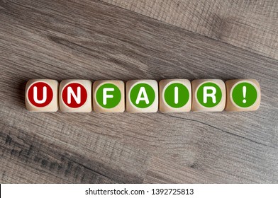 Cubes And Dice With Fair And Unfair On Wooden Background