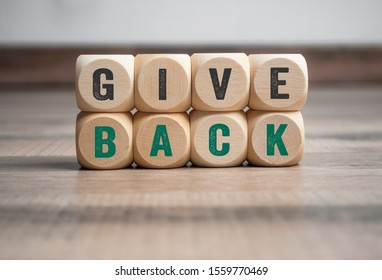 Cubes And Dice With Message Give Back On Wooden Background