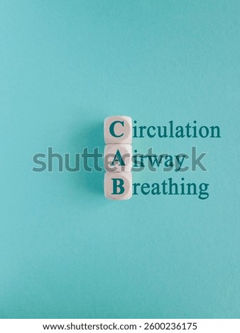 Cubes form the acronym CAB (Circulation, Airway, Breathing). Beautiful blue background, copy space. Symbol for basic life support.