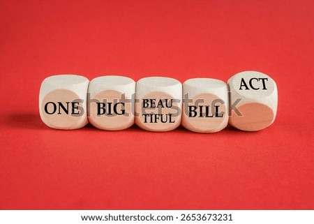 Cubes form the expression One big beautiful bill act. Beautiful red background. Business concept. Copy space.