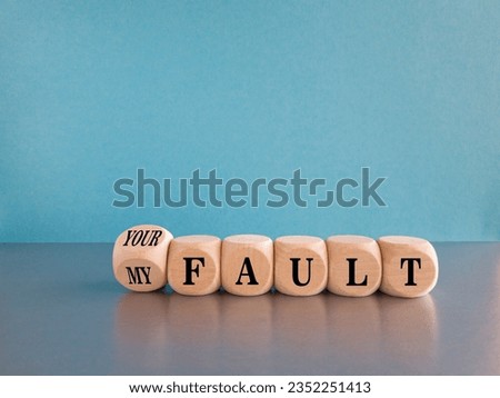 Cubes form words My fault or your fault. Beautiful blue background, grey table. Copy space. Concept of problems and conflicts in business and society. Social problems