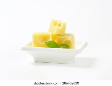 Cubes Of Fresh Emmental Cheese In White Bowl