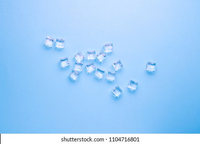 Cubes of ice on a light blue background. Flat lay, top view.
