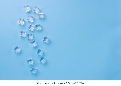 Cubes of ice on a light blue background. Flat lay, top view.
