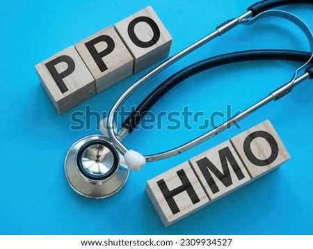 Cubes with letters PPO and HMO near a stethoscope.
