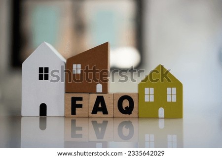 Cubes with message FAQ surrounded by wood home. Quesiton and answer about housing problems