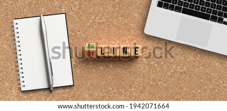 cubes with message ONLINE and OFFLINE surrounded by office items on cork background