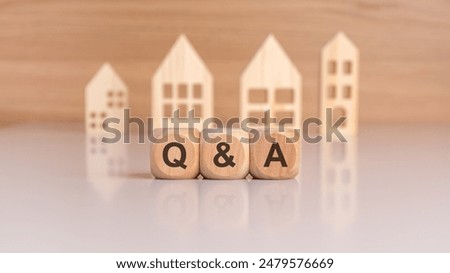 cubes with message Q and A surrounded by wood home. question and answer concept