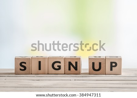 Cubes with the message sign up on a table