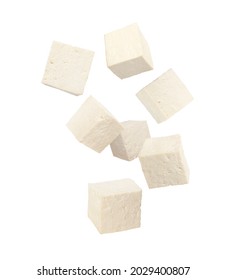 Cubes of raw tofu falling on white background - Shutterstock ID 2029400807