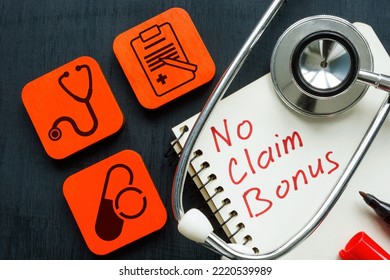 Cubes, Stethoscope And Notepad With No Claim Bonus In Health Insurance.