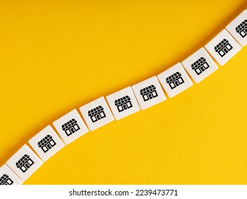 Cubes with store icons on yellow background. Business franchise or chain store concept. - Shutterstock ID 2239473771