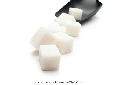 Cubes of sugar with plastic spoon