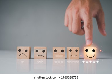 Cubes Wooden Are With Various Emoji Icons Happy And Angry A Hand Pointing At Smiley Icon Five Stars Response From Customer To Satisfaction Receive. Impressive Shopping Or Service A Great Experience.